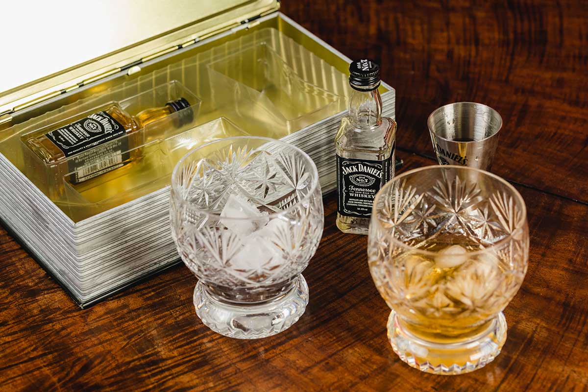 Jack Daniel's packaging with two glasses and ice, case and bottle